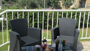 A balcony with wicker chairs and a table, overlooking a scenic view of a lake and mountains. - Semi-detached Villa Sea View - Private Parking - Near Town Center and Beaches (Propriano)