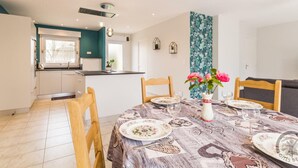 A modern kitchen with a dining area.