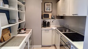 A compact kitchen with white cabinets, a microwave, a toaster, and a sink. - N&J -  ANGEL'S BAY - Central - Close sea (Niza)