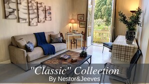 A cozy living room with a sofa, coffee table, and artwork on the wall. - N&J -  ANGEL'S BAY - Central - Close sea (Niza)