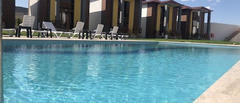 Seasonal outdoor pool, open 9:00 AM to 9:00 PM, free pool cabanas