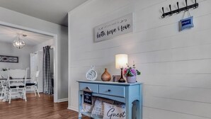 A hallway with a light blue console table, a wall clock, and a sign that says "all you need is faith, hope & love". - Location! Location!<br>Minutes to all shopping and your favorites restaurant!  (Cullman)