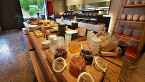 A buffet with various food items and condiments. - Grand Hotel Hradec (Pec pod Snezkou)