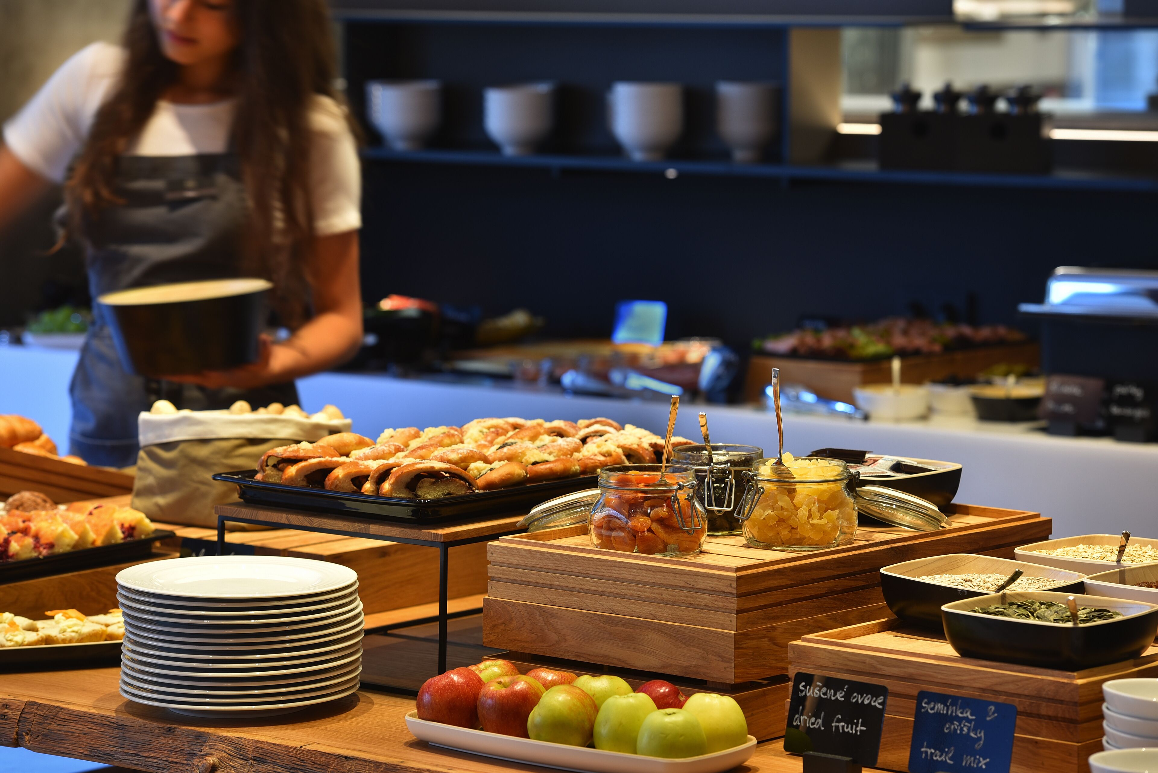 A buffet with various food items and a sign indicating semolina overcooked fruit and trail mix.