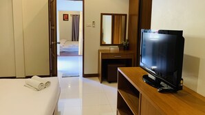A hotel room with a bed, a desk, a television, and a bathroom visible through an open door. - Srisupawadee Resort (Prachuap Khiri Khan)