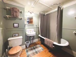 A bathroom with a toilet, sink, and bathtub. - Premier Cabin 1 with Lake View (Paul Smiths)