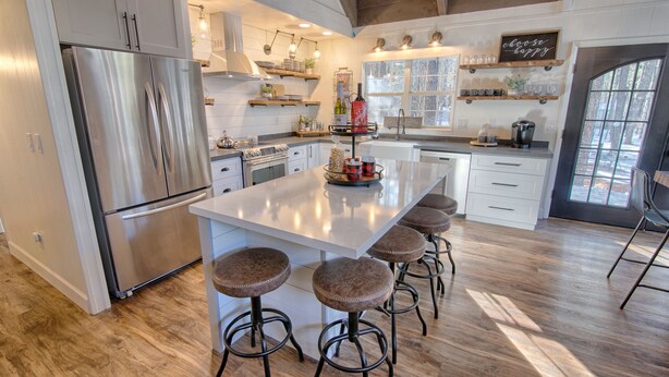 A spacious kitchen with a large island, stainless steel appliances, and wooden flooring. - #AzStoneCabin- Finest Luxury Cabin In Pinetop- Lakeside! (Pinetop)
