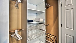 A walk-in closet with open shelves, a hanging rod, and a shoe rack. - Cute & Cozy PDX Area Townhouse: 31 Mi to Mt. Hood! (Boring)