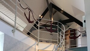 A staircase with a metal railing and a decorative anchor.