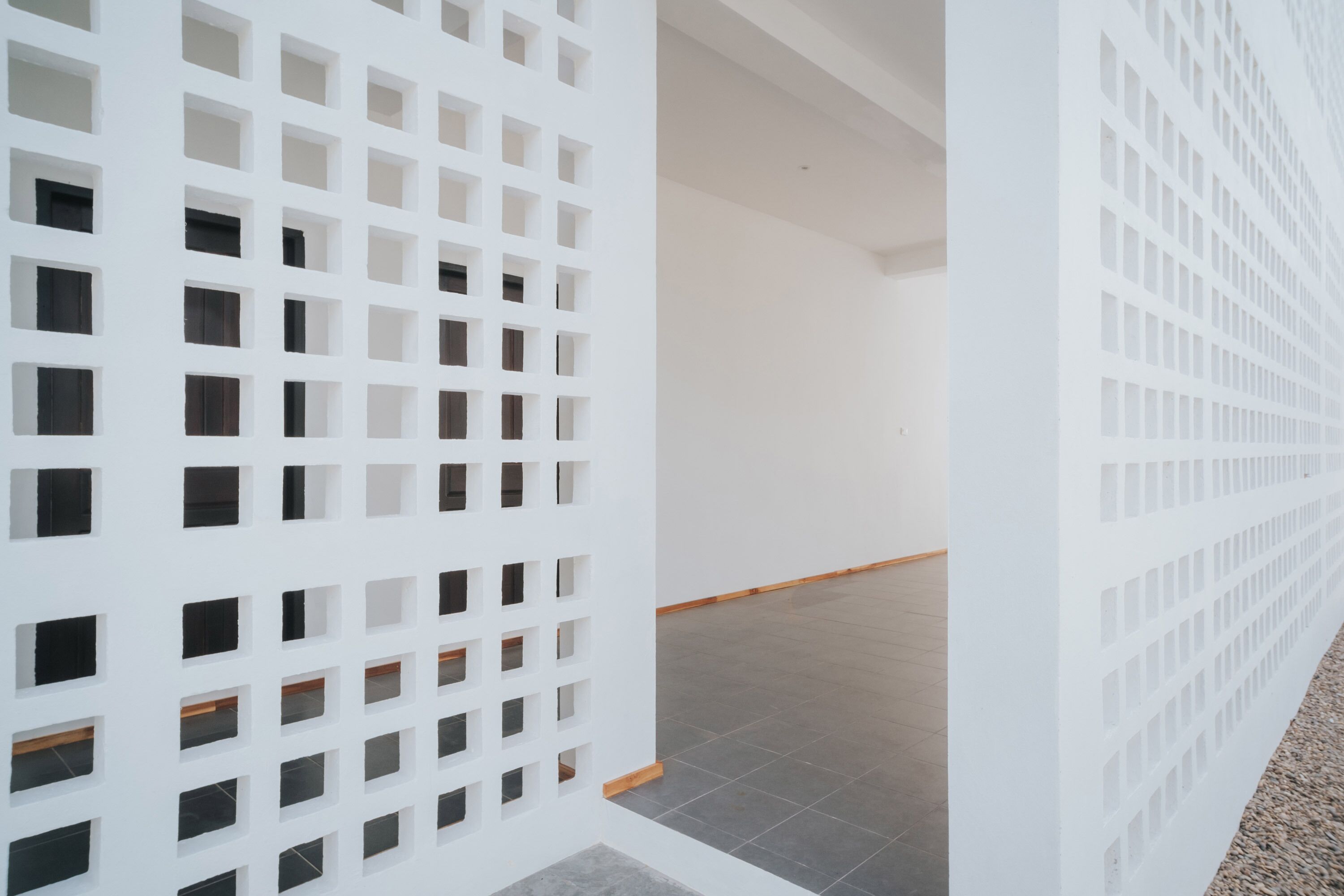 A white partition with a grid of square openings.