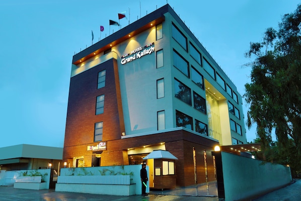 A hotel with a modern design, featuring a prominent sign for the Grand Kallash.
