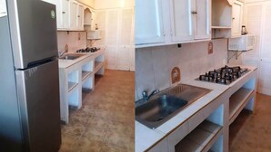 A compact kitchen with a refrigerator, stove, sink, and white cabinets. - Teques Vacation Home, Golden Zone "Las Alas" Lake View (Tequesquitengo)