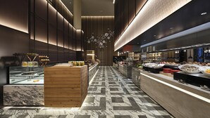 A modern hotel lobby with a central reception desk, a marble-tiled floor, and a wall-mounted light fixture. - HUALUXE Nanjing Yangtze River by IHG (Nanjing)