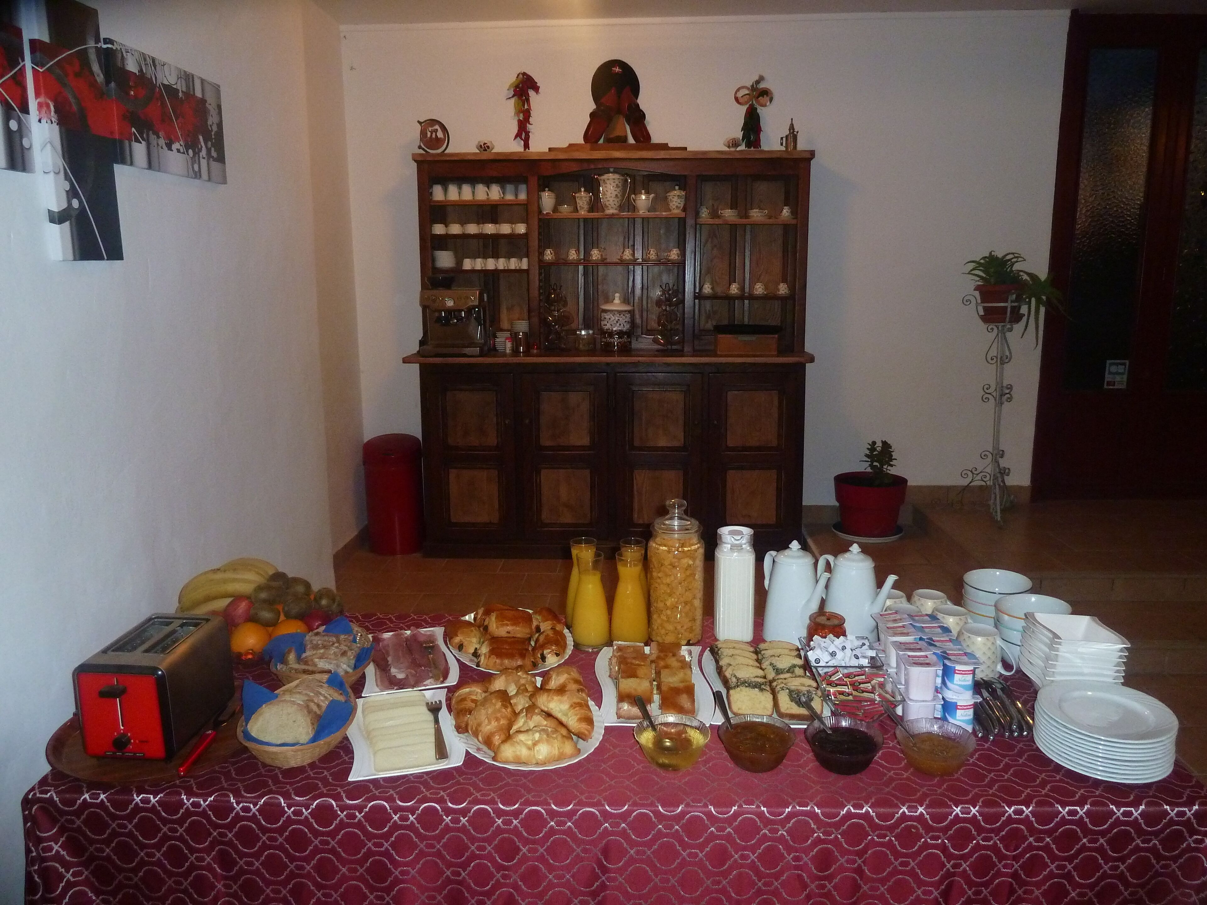 A buffet table with various food items and a coffee station.