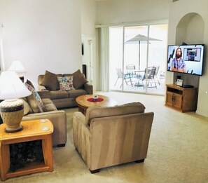 Relax in a comfortable seating area with a sofa, armchairs, and a coffee table.