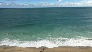 A beach with clear turquoise water and a sandy shore. - Beach Paradise Found!  Direct oceanfront 9th floor updated and nicely decorated (Jensen Beach)