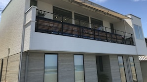 A modern two-story building with a balcony, large windows, and a flat roof. - Villa Ocean Kamaguchi (Awaji)