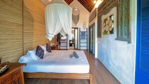 A bedroom with a canopy bed, wooden ceiling, and a view of the outside.
