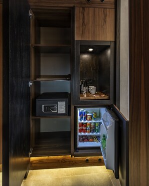 A compact kitchen with a built-in refrigerator, a coffee maker, and a microwave. - Hotel Bosfora Plus (Istanbul)