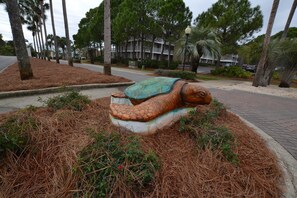 Stunning sculpture of a turtle set amidst lush greenery and a variety of shrubs.