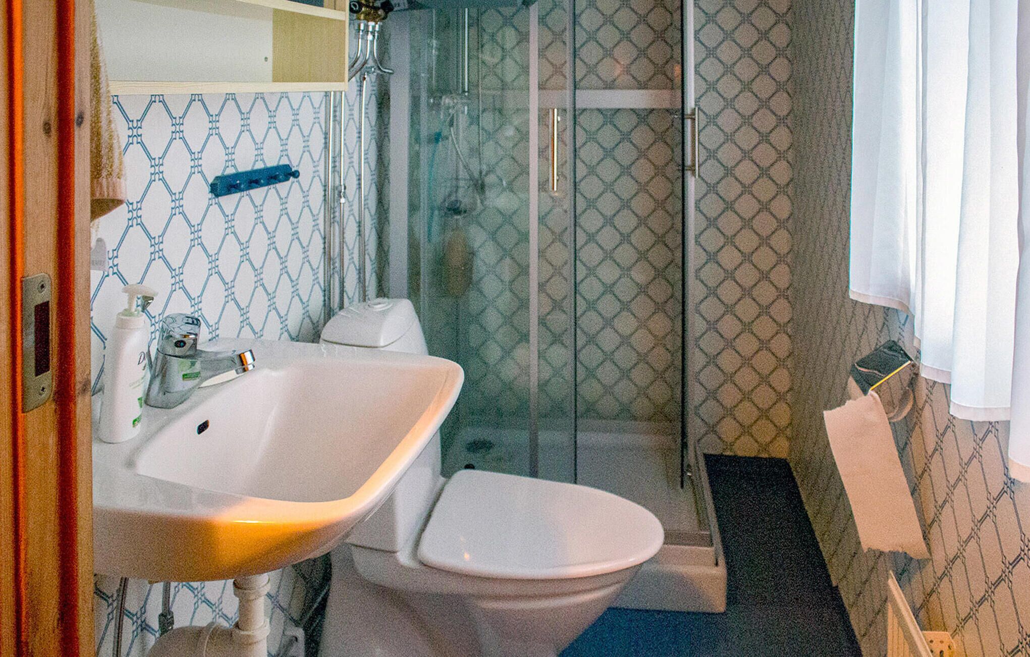 A bathroom with a sink, toilet, and shower.