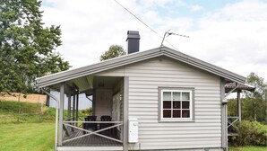 A small, single-story house with a covered porch and a chimney. - 2 bedroom amazing home in Burseryd (Burseryd)