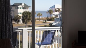 A room with a view of the beach, a chair, and a TV. - Beautiful ocean views all rooms. Very close to beach. Four bedrooms, 3.5 baths. (St. Helena Island)