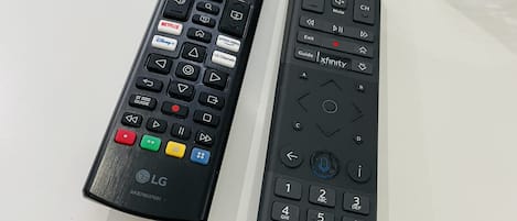 Two remote controls on a white surface.