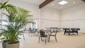 A spacious indoor area with tables and chairs, a ping pong table, and a pool table. - Feriehotal Tranum Klit (Brovst)