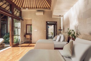 A modern hotel room with a large window, a wooden ceiling, and a view of the garden.