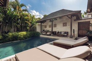A poolside area with lounge chairs, a bar, and a covered seating area. - Asvara Villa Ubud by Ini Vie Hospitality (Ubud)