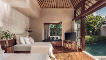 A bedroom with a large bed, a TV, and a view of a swimming pool.
