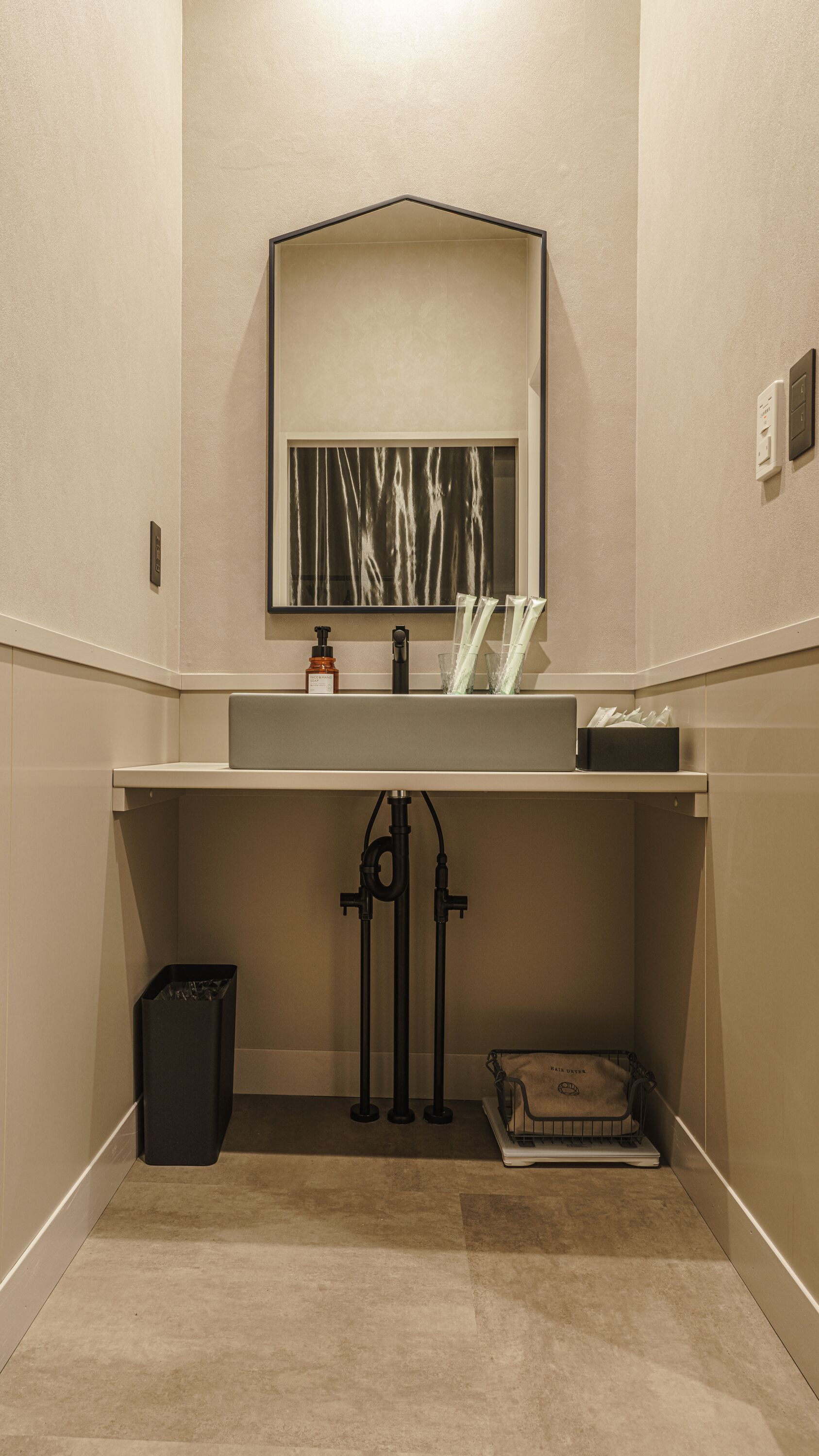 A bathroom with a sink, mirror, and towel rack.