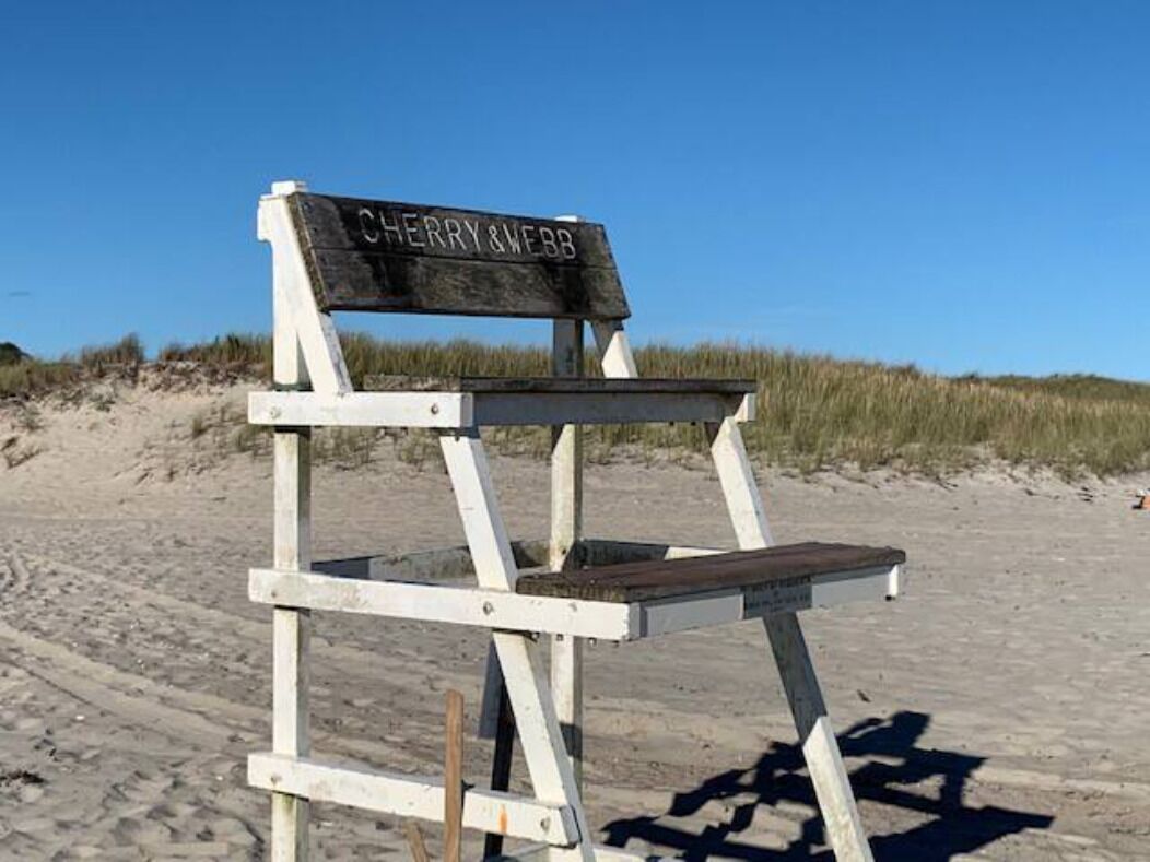 A beach chair with a sign that reads "CHERRY & WEBB".