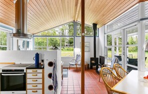 Enjoy meals in the spacious kitchen and dining area with a view of the garden.