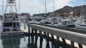 A marina with multiple boats docked at a concrete pier. - Luxurious Condo with Ocean view near to San Jose (San José del Cabo)
