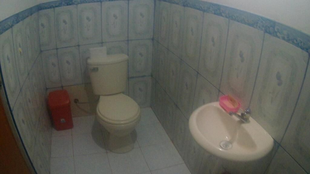 A bathroom with a toilet, bidet, and sink.