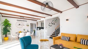 A modern living room with a sofa, chairs, a coffee table, and a staircase leading to another level. - Amazing home in Kastel Sucurac (Kastel Sucurac)