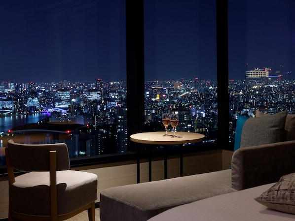 A modern room with a city view, a round table with glasses, a sofa, and a chair. - Mitsui Garden Hotel Toyosu Premier Tokyo (Tokyo)