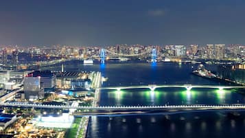A nighttime cityscape with illuminated bridges and buildings.