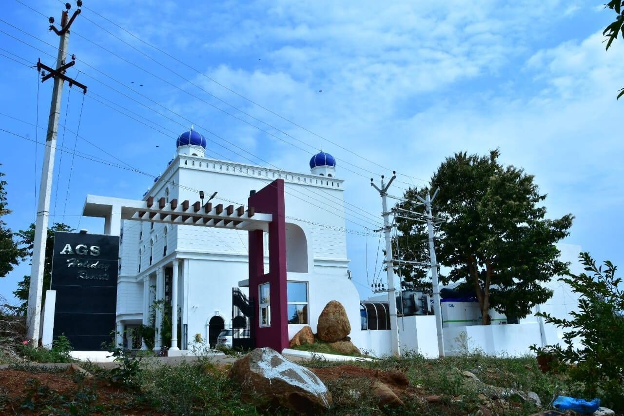 A white building with a blue dome and a red archway, labeled "AGS."