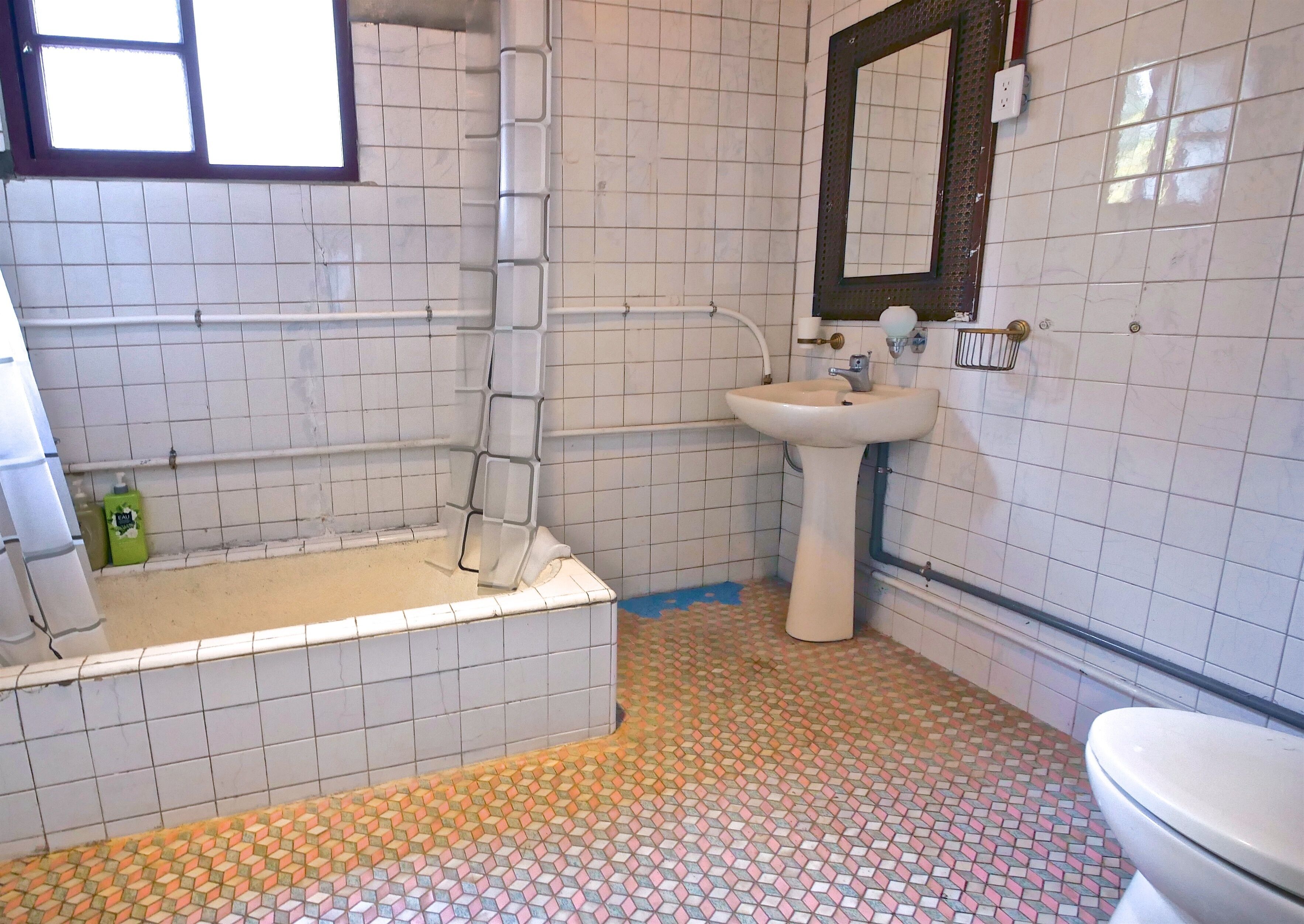 A bathroom with a bathtub, a sink, and a toilet.