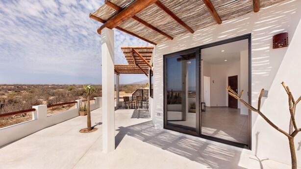 A modern house with a balcony, a cactus, and a view of the desert landscape. - CASA TAKO 2, CLEAN modern studio unit, 5 minutes walk to kite launch beach. (La Ventana)