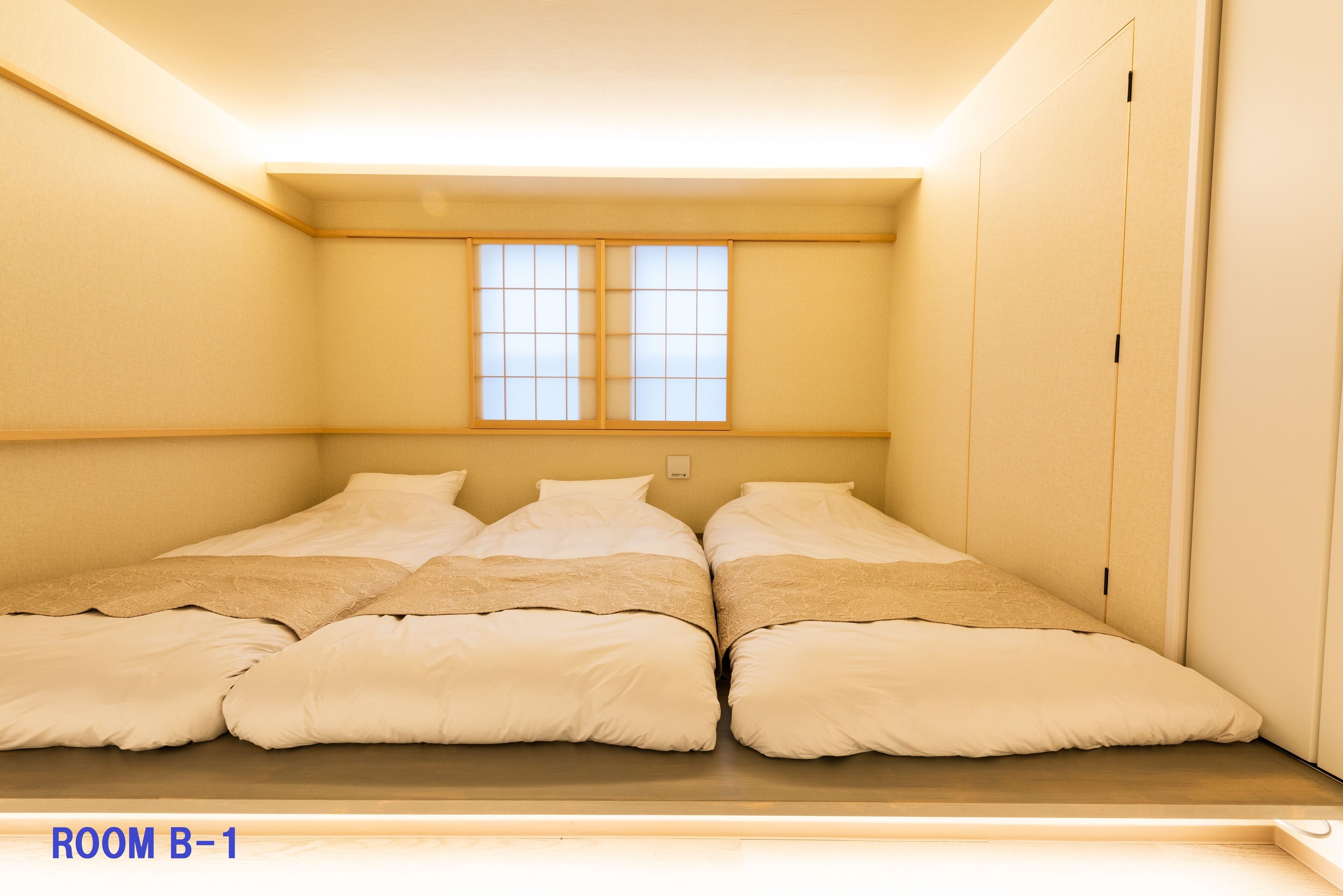 A room with a bed, a window, and a wardrobe.