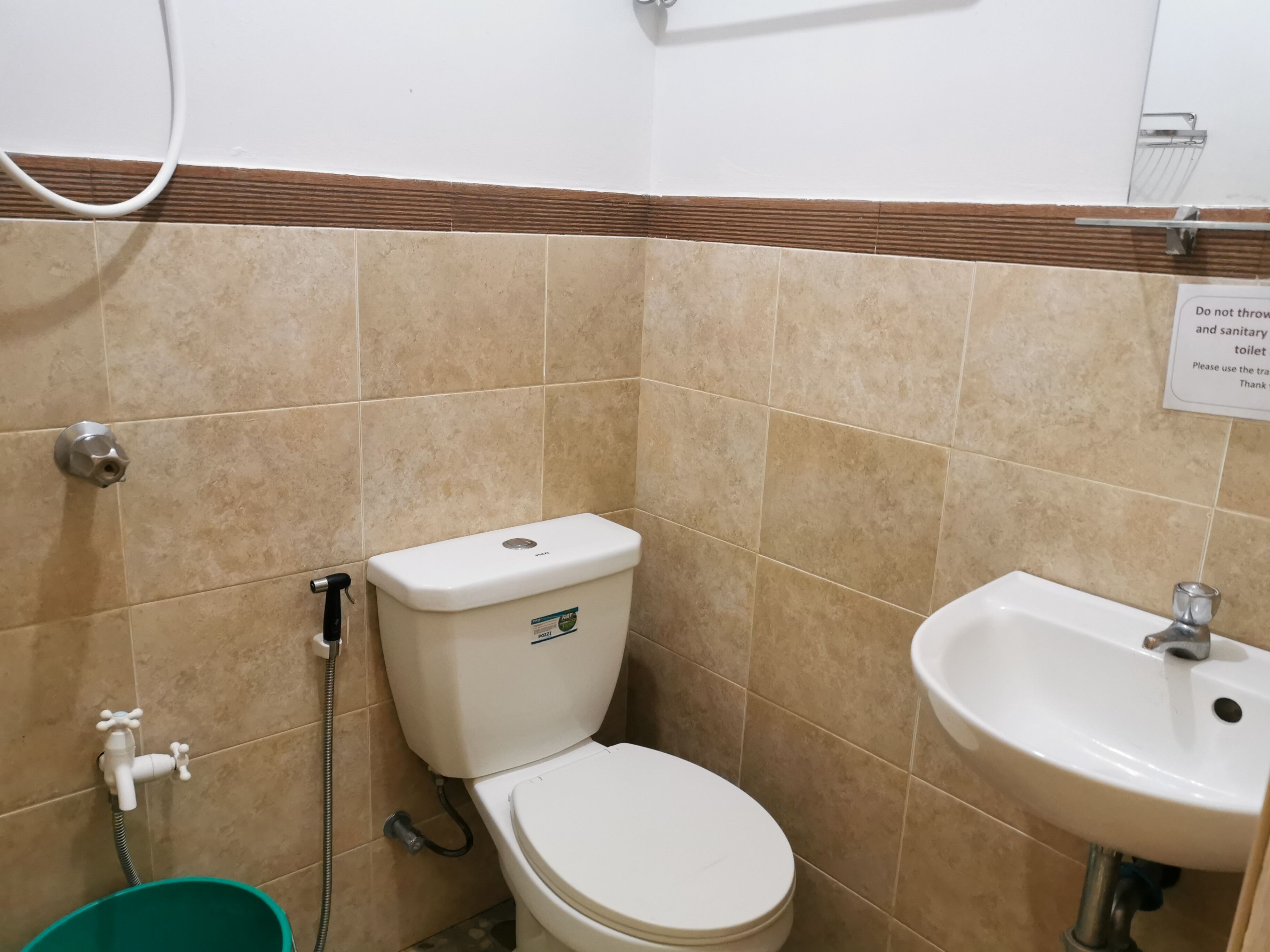 A bathroom with a toilet, sink, and shower.