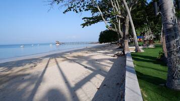 On the beach, white sand, beach umbrellas, beach towels