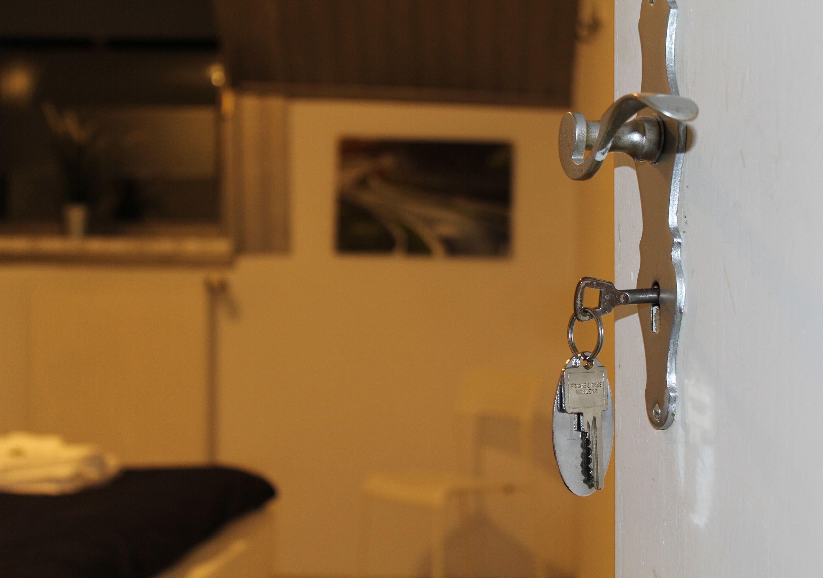 A door with a key lock and a keychain.