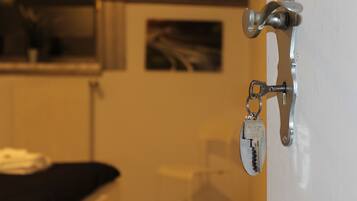 A door with a key lock and a keychain.