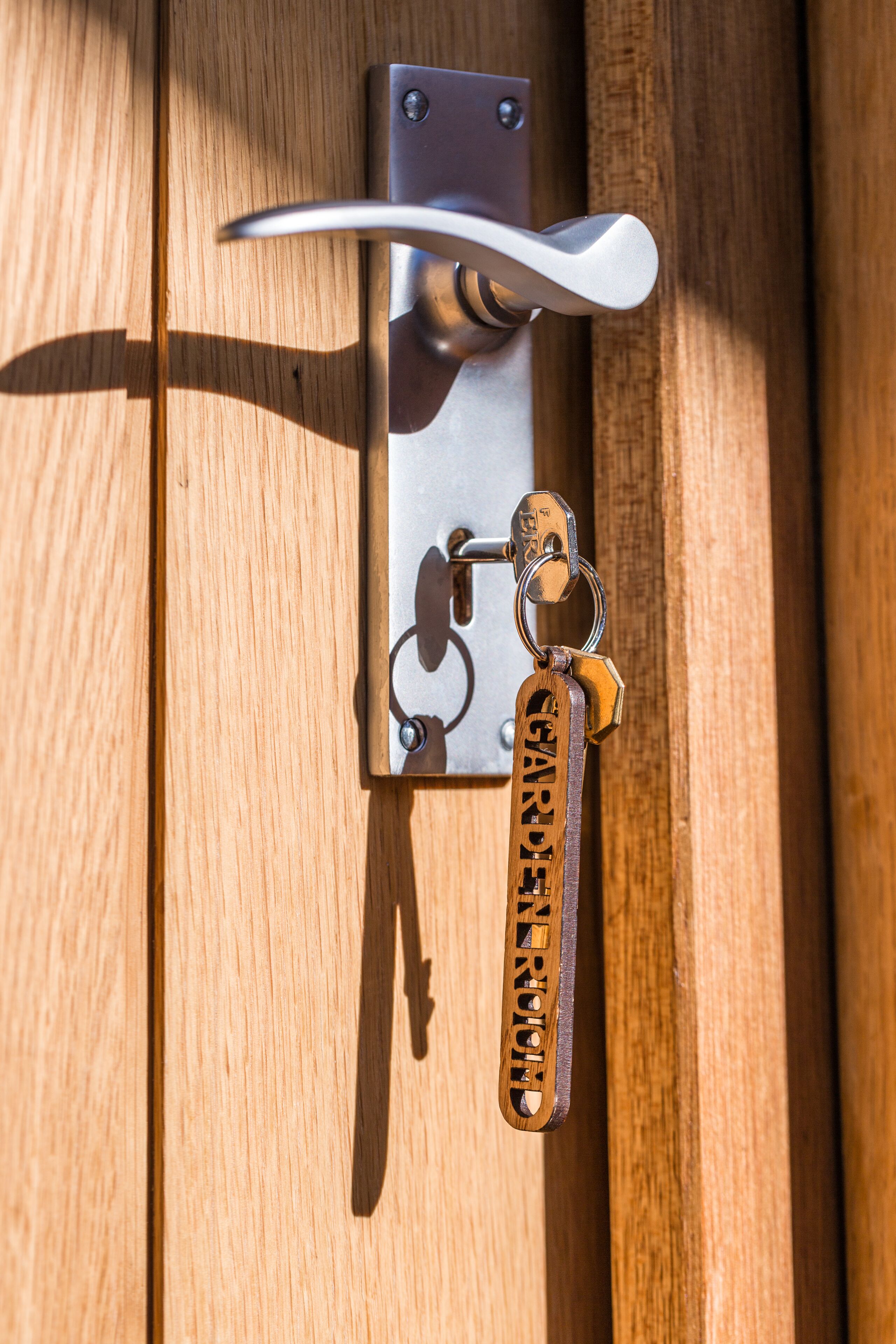 A door with a metal handle and a keyring.