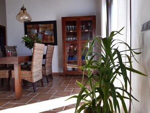 Enjoy meals in this cozy dining area with a wooden table and wicker chairs.
